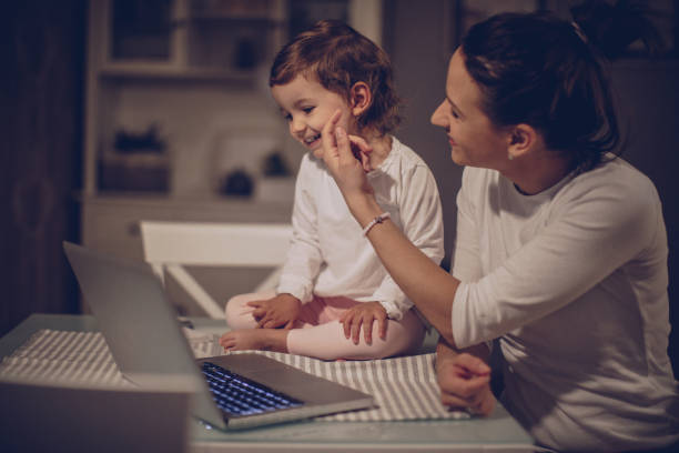 istock Mother and baby daughter using laptop 942751722