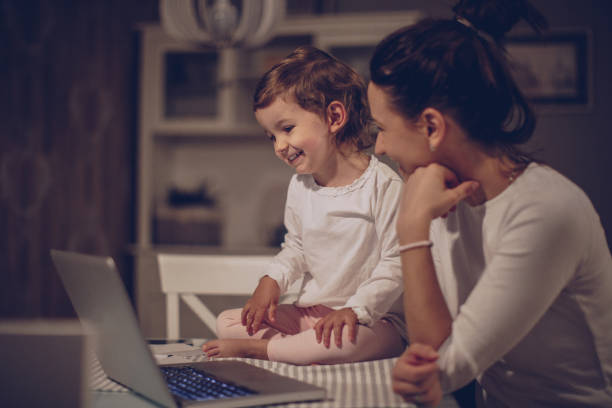 istock Mother and baby girl using laptop 942752784