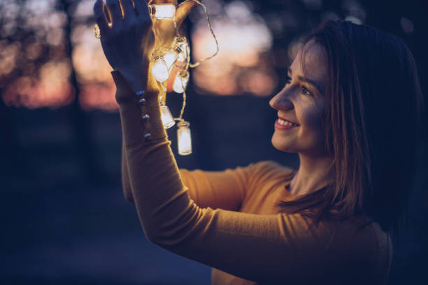 istock Smiling woman holding lights 942755322