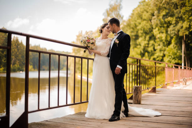 istock Young and attractive wedding couple on the bridge 942756140
