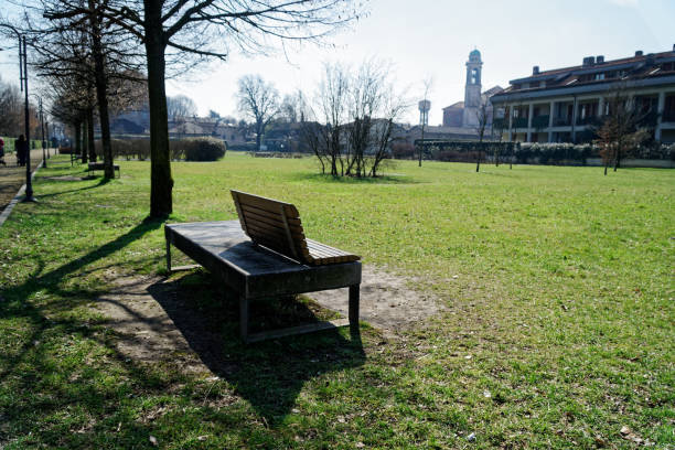 istock Art Bench in public park, loneliness at clear sunny spring day 942756172