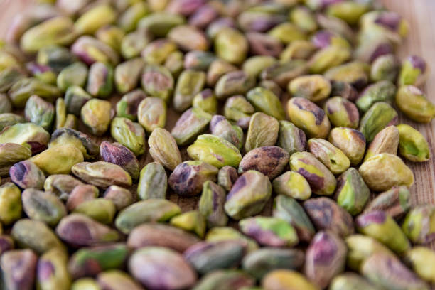 istock Pistachio Nuts shelled on wood 942756252
