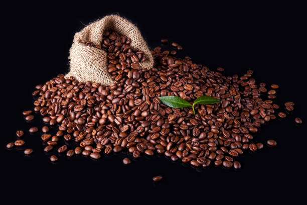 coffee beans on a black background - sack burlap bag roasted imagens e fotografias de stock