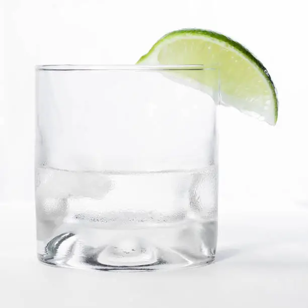 Photo of clear beverage over white