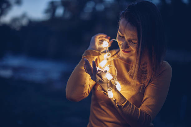 istock Pretty woman holding lights 942762550