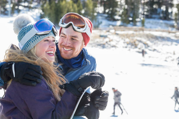 istock Smiling young couple prepare to ski together 942764748