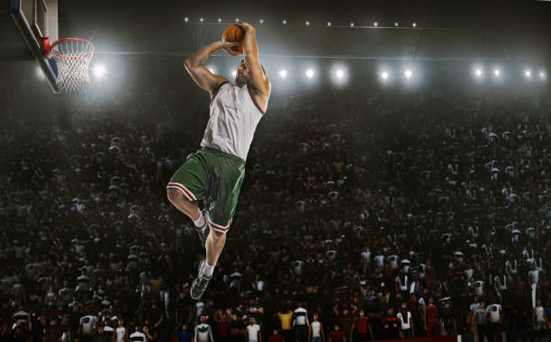 istock one basketball player jump in stadium panorama view 942777300