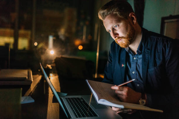 istock Businessman working late night in the office 942784452