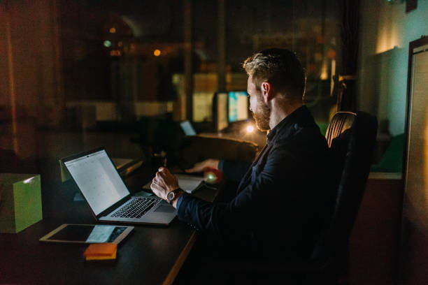 istock Businessman working late night in the office 942785446