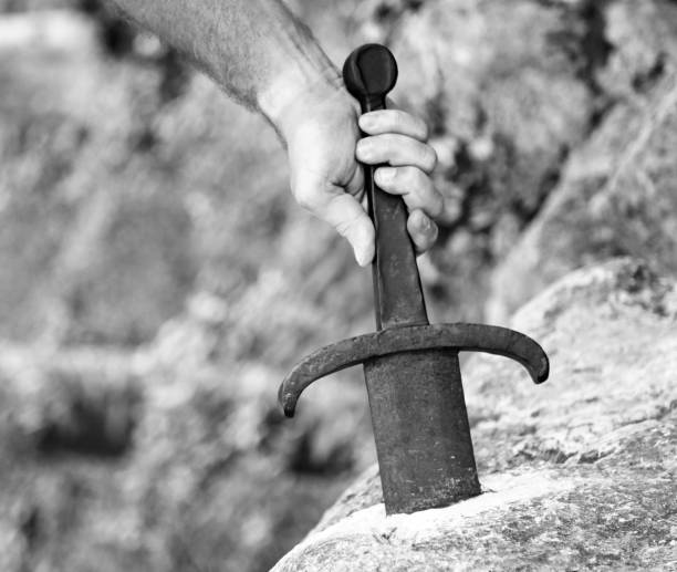 istock knight who extracts Excalibur the legendary sword in the stone 942785474