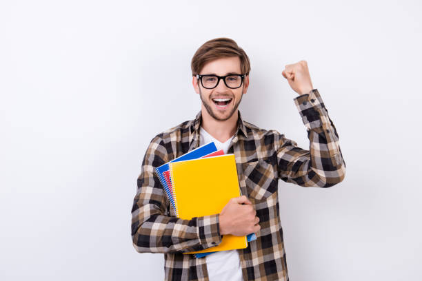 istock Yes! Happy handsome student in spectacles having an exelent mark for exam. 942788452