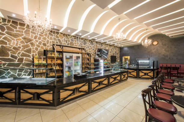 istock Bakery cafe restaurant interior, empty seats and glasses shelves 942788712