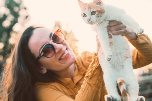 istock smiling woman holding a cat 942796740