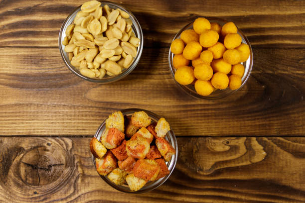 istock Mix of snacks for beer on wooden table 942800238