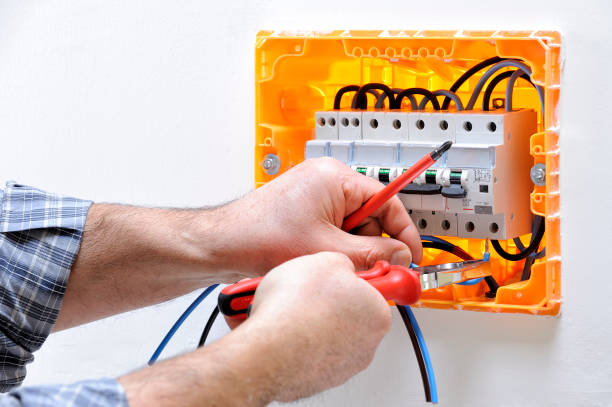 Electrician technician at work on a residential electric panel Electrician technician working on a residential electric panel, he inserts the cable in the magnetothermic switch terminals cable tester stock pictures, royalty-free photos & images