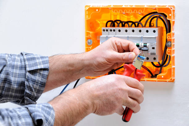 Electrician technician at work on a residential electric panel Electrician technician working on a residential electric panel, cuts the cable with a cable cutter cable tester stock pictures, royalty-free photos & images