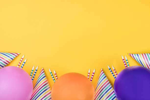 istock Birthday party composition on yellow background. Top view with copy space. 942809332