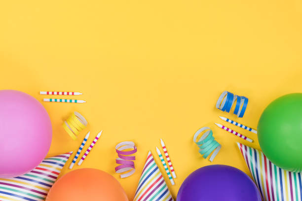 istock Birthday party composition on yellow background. Top view with copy space. 942809346