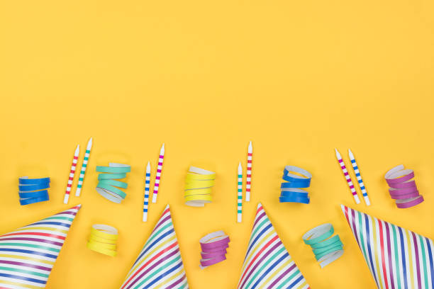 istock Birthday party composition on yellow background. Top view with copy space. 942809350