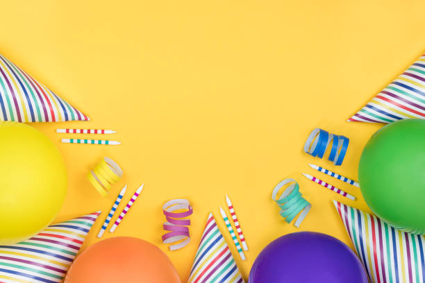 Birthday party composition on yellow background. Top view with copy space.