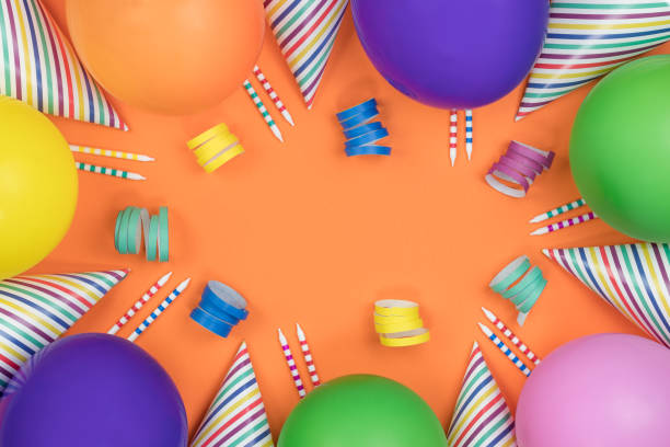 istock Birthday party composition on orange background. Top view with copy space. 942809432