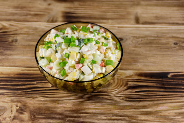 istock Salad with crab sticks, sweet corn, cucumber, eggs, rice and mayonnaise 942809458