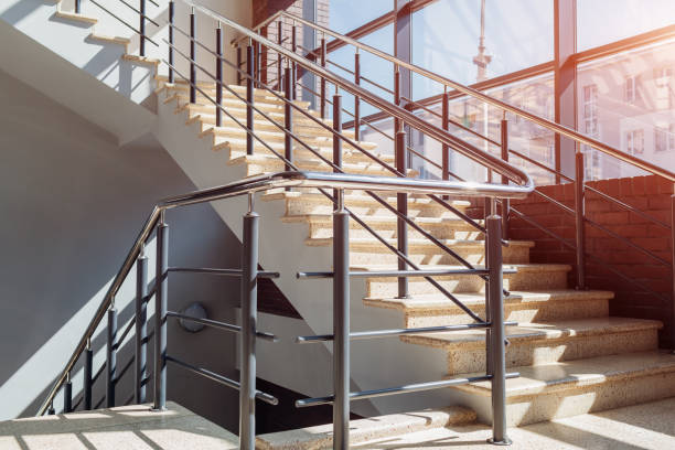 Staircase in modern buisness center building. Emergency exit. Stairs in shopping center. White ladder by window Staircase in modern buisness center building. Emergency exit. Stairs in shopping center. White ladder by window in hotel. railing photos stock pictures, royalty-free photos & images