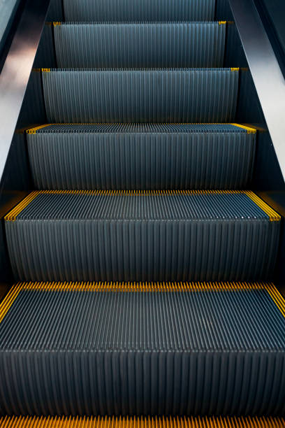 istock Modern escalator in shopping center. Electronic system moving. Empty escalator 942809804