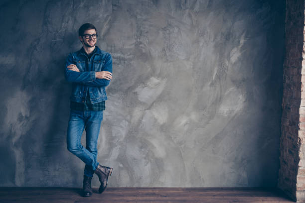 istock Confident cute smart man with crossed hands in jeans 942810146