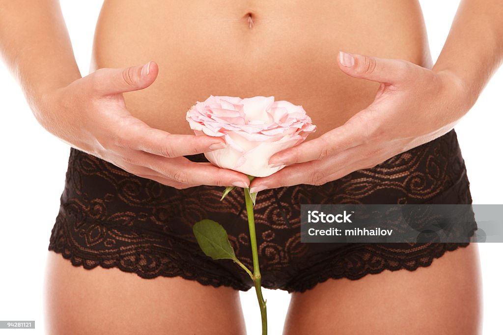 Young woman holding rose in front of vagina maroon panties Young woman buttocks over isolated white background Close-up Stock Photo