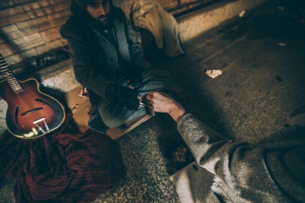 istock Giving homeless money 942813568