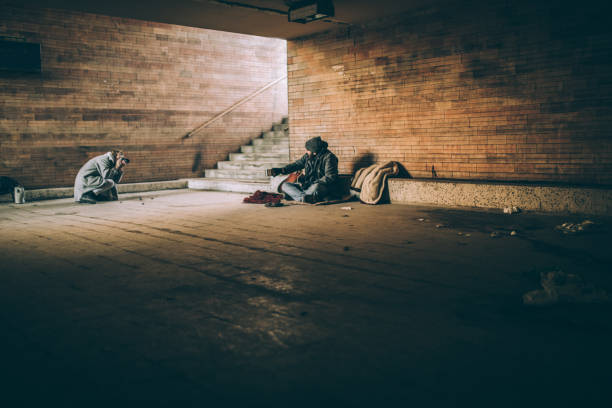 istock Homeless man sitting and pleading 942816248