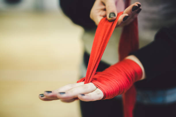 istock Female hands putting on boxing tape 942819614