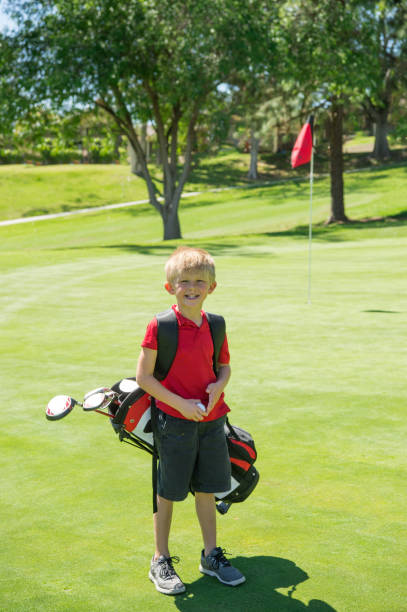 istock Junior Golfer Walking To The Green 942826758