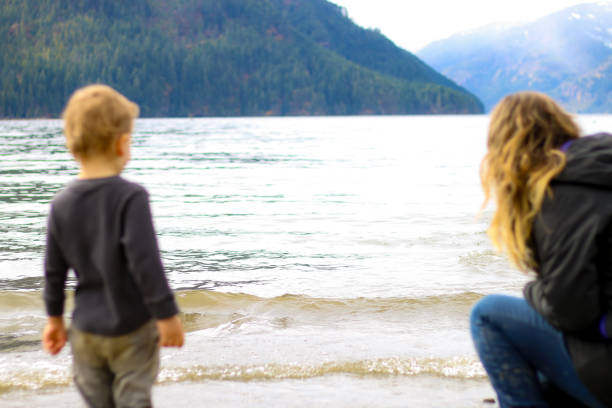 istock Mother and Child at Beach Playing 942835978