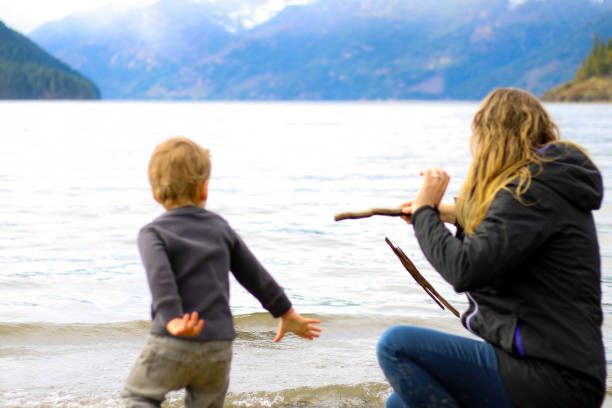 istock Mother and Child at Beach Playing 942836356