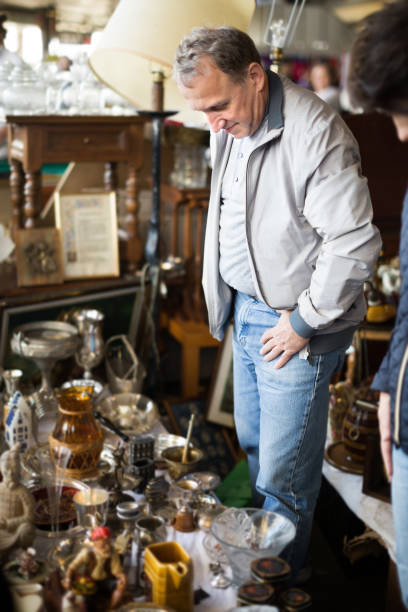 istock Adult man is looking old things at the fleamarket 942836826