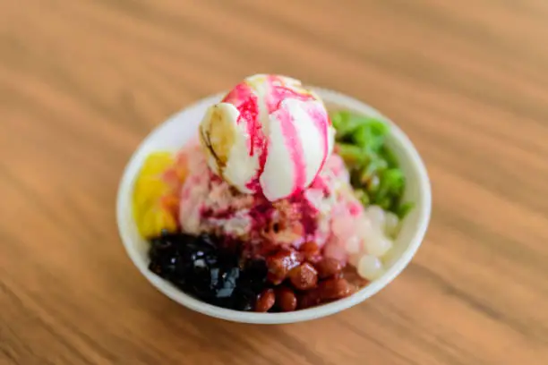 Photo of Soft focus of Ais Kacang topped with basil seeds, peanuts, corn, and a scoop of ice cream.