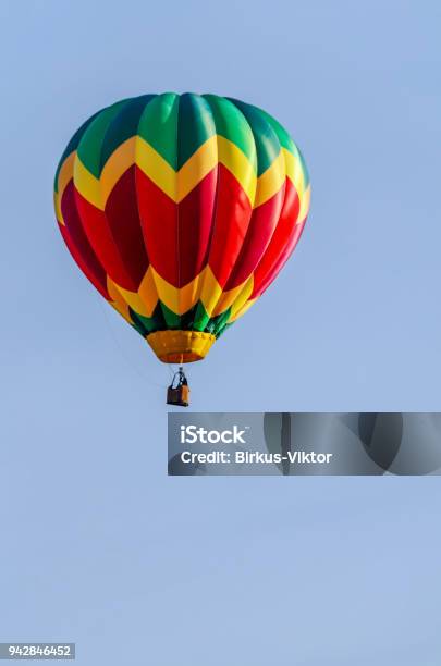 Colorful Balloon With A Basket Flies In A Blue Sky Stock Photo - Download Image Now - Adventure, Aerostat, Air Vehicle