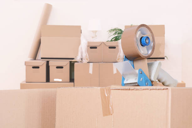 istock Tape dispenser sealing a shipping cardboard box 942847140