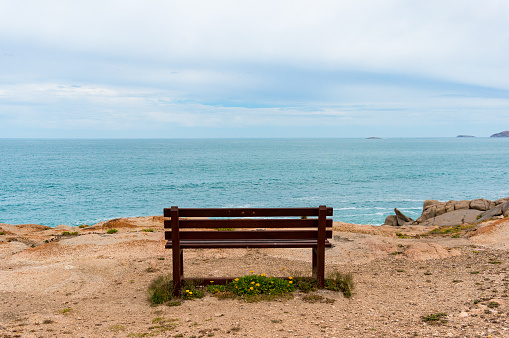 Empty bench with picturesque view towards the open ocean, sea. Spectacular nature background
