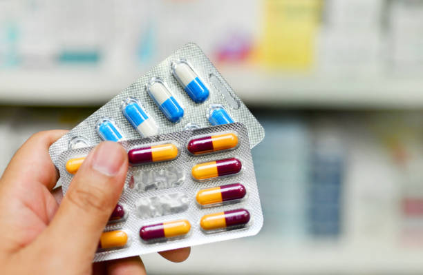 istock Pharmacist holding medicine two capsule pack 942857242