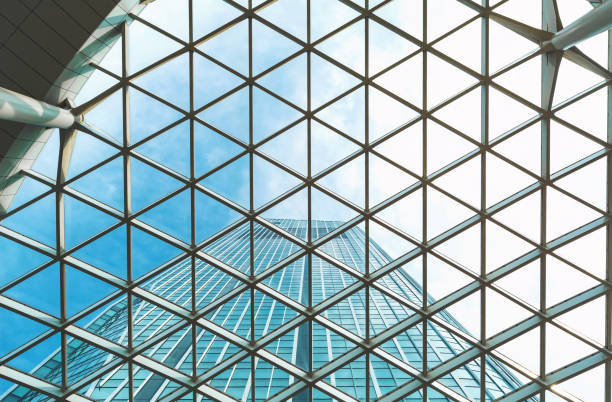 istock Looking up at a skyscraper and the sky above 942857526