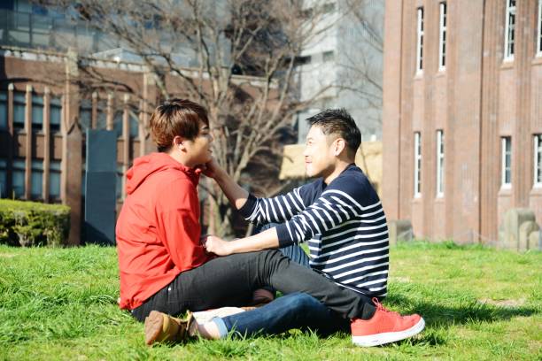 istock Young same sex couples date in the park 942870422