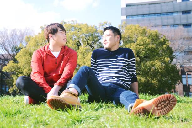 istock Young same sex couples date in the park 942870426