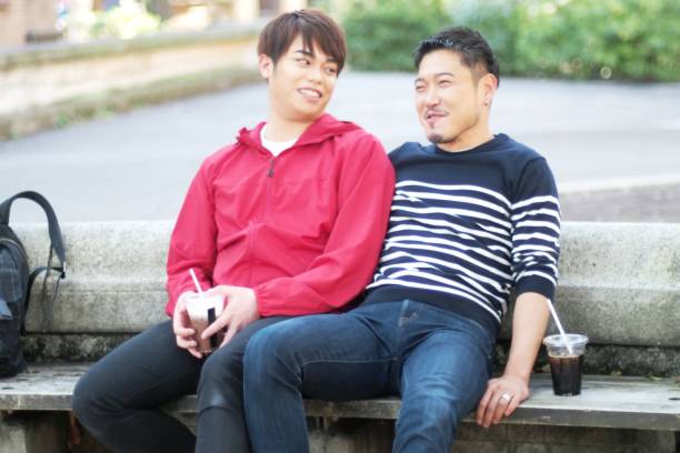 istock Young same sex couples date in the park 942870468