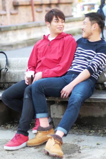 istock Young same sex couples date in the park 942870470
