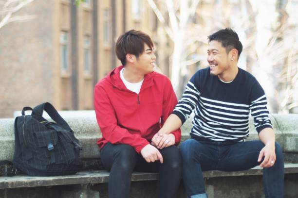 istock Young same sex couples date in the park 942870474