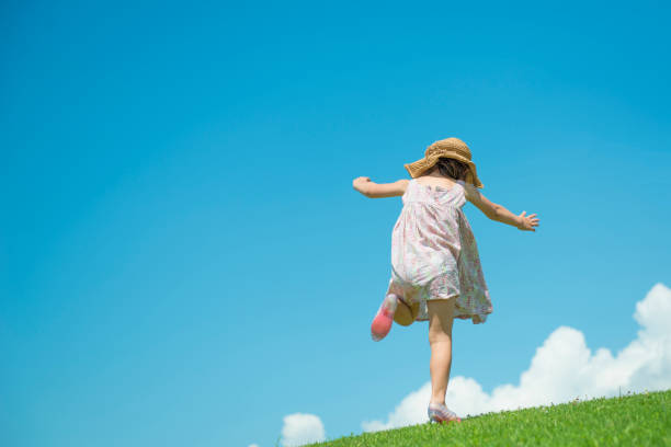 Little girls play in the meadow