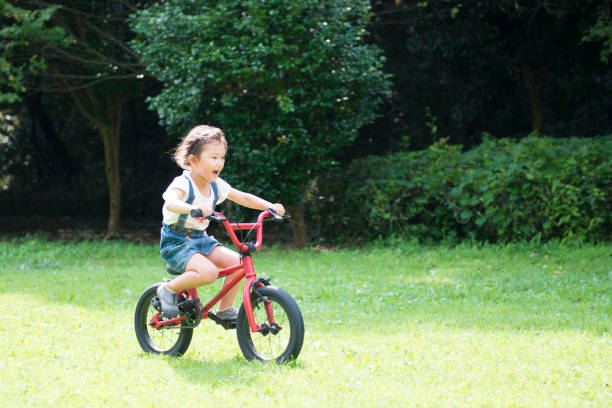 istock Little girl play on the bicycle 942877754